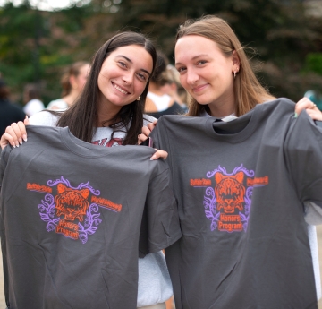 Students holding honors t-shirts